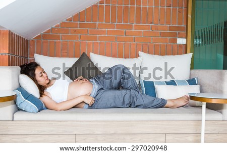 Asian woman sleeps on the chair with happy emotion.