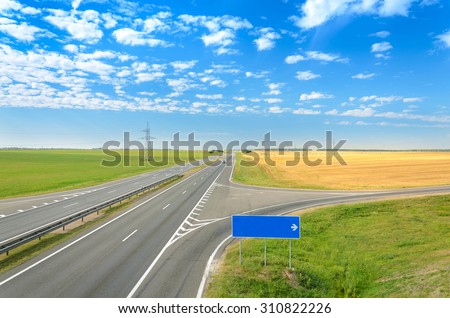 Asphalt road. Blank road sign - right turn.