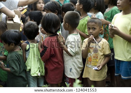 CAGAYAN DE ORO PHILIPPINES DEC 20 unidentified children in Mindanao which was hit by storm Sendong smile when they line up for relief on December 20 2011 in Cagayan de Oro Philippines CAGAYAN DE ORO PHILIPPINES DEC 20 unidentified children in Mindanao which was hit by storm Sendong smile when they line up for relief on December 20 2011 in Cagayan de Oro Philippines