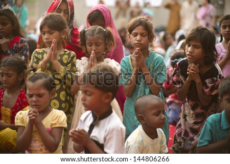 Lahore, Pakistan- Aug 2 2012: Unidentified Children In A Slum Prayed For Better Future Of The Community On August 2 2012 In Lahore, Pakistan. Children In Pakistan Suffer From Poor Education.