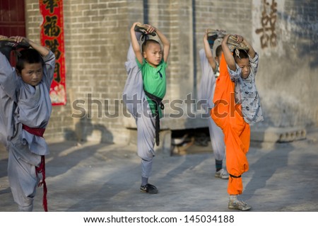 CHINA - JUNE 14: ShaoLin school Kung Fu boys trainings outdoors, June 14, 2012. This is a popular and prestigious school in China near Shaolin Monastery which caters to more than 10,000 boys