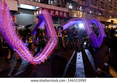HONG KONG-MAR 6: People play glowing dragon dance in Tai Kok Tsui Temple Festival Dragon on March 6, 2011. It is one the Chinese intangible cultural heritage in this traditional neighborhood.