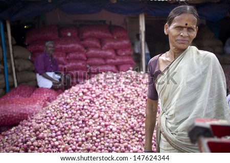 TRICHY, INDIA - AUG 3: Unidentified Indian woman segregate onion on August 3, 2012 in Trichy, India. Amongst the onion producing countries in the world India ranks second in area and production.