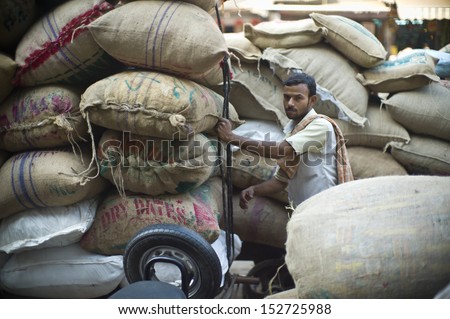 DELHI, INDIA - NOV 18: Unidentified Indian man works in a classical street in Old Delhi. November 18, 2012 in Delhi, India. The lifestyle in old delhi is still well kept like that in 100 years ago.