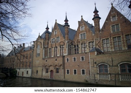 BRUGES, BELGIUM - NOV 30: Houses along the canals of Brugge or Bruges, Belgium on November 20, 2012. Bruges is frequently referred to as \
