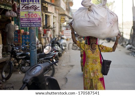 JODHPUR, INDIA - FEB 1: An unidentified woman in colorful attire is shopping in the market on February 1, 2013 in Jodhpur, India. The clothes of Rajasthan woman are famous for the color.