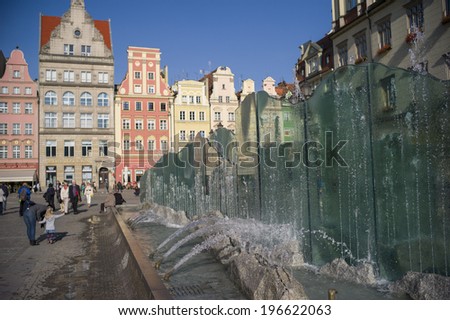 WROCLAW, POLAND - OCT 25: The modern water fountain on Main Market Square on October 25, 2013 in Wroclaw, Poland. The plaza itself is one of the largest medieval squares in Poland and even in Europe.