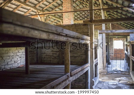 OSWIECIM, POLAND - OCT 29: A row of bunk beds at a concentration camp memorial site on October 29, 2013 in Oswiecim, Poland