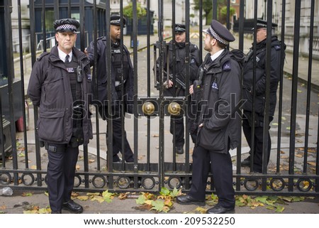 LONDON, UK - NOV6: Police officers guard the door of 10 Downing Street in London, UK on November 6, 2013. British PM David Cameron is working and living in the premise.