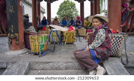 DALI, CHINA - MAY14 : A local, from Bai ethnics, on the street located in Dali Old City, Yunnan, China on May 14 2014. Dali is now a major tourist destination for domestic and international tourists
