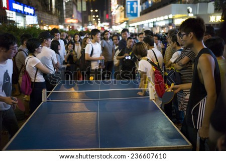 HONG KONG - OCT 15: People gather together and play table tennis in the middle of the road during Occupy Central movement in Mongkok in Hong Kong on October 15 2014.