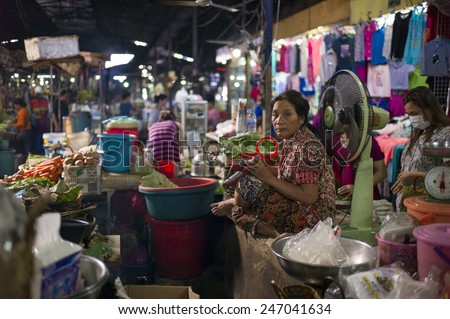 PHNOM PENH, CAMBODIA - NOV 17: The local seller in Toul Tom Poung Market, Phnom Penh, Cambodia on November 17 2014. It is also called Russian Market which is a good place for souvenirs.