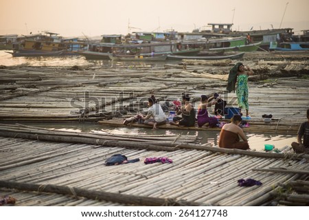 MANDALAY, MYANMAR - MAR 5: A shanty town built on bamboo poles tied together with locals going about their daily lives on the riverbank of the town of Mandalay, Myanmar on the 5 March 2015.