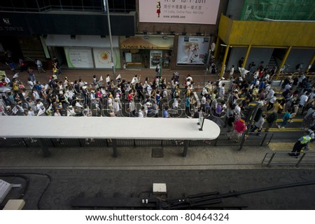 HONG KONG, CHINA - JULY 1: People going to protest for the government policy in Hong Kong on the anniversary of Handover Day on July 1, 2011 in Hong Kong, China.