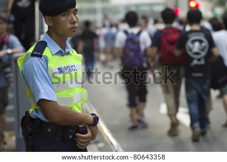 HONG KONG, CHINA - JULY 1: Unidentified policeman on duty at government policy protest in Hong Kong on the anniversary of Handover Day on July 1, 2011 in Hong Kong, China.