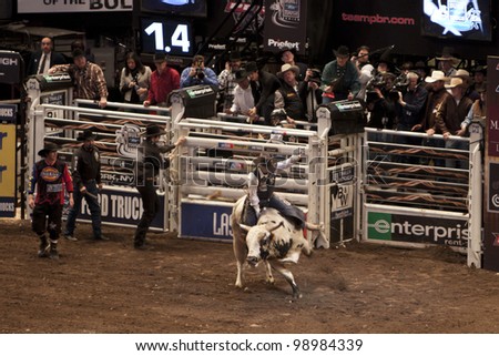 NEW YORK - JAN 10: An unidentified bull rider tried to stay on the bull for 8 seconds during the Professional Bull Rider tournament on January 10, 2009 in New York, NY.