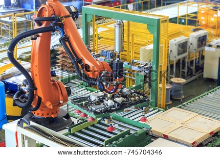 Factory 4.0 concept. Industrial robot in smart warehouse system for manufacture factory