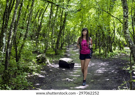 young caucasian female hiking in the wood