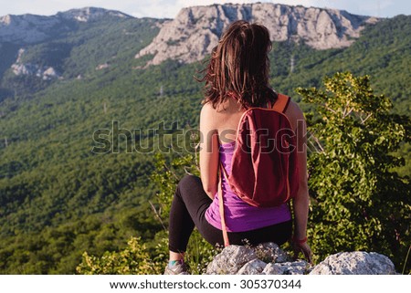 happy young female hiking in mountains healthy and active lifestyle. beautiful girl on nature background