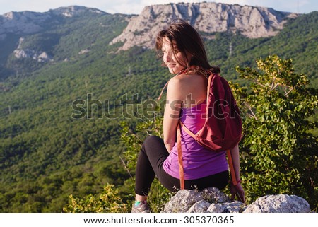 happy young female hiking in mountains healthy and active lifestyle. beautiful girl on nature background
