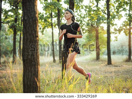 young caucasian female running in park. Female jogging in park