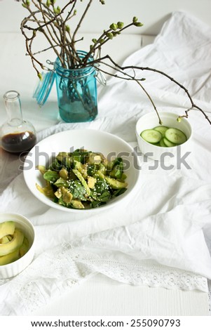Avocado and spinach salad served on the white table