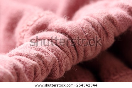 Close up photo of a pink soft wool fabric. Nice texture and light effect.