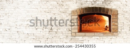 Typical Italian oven for bread and pizza. Nice fire light and colors. Horizontal photo with bricks texture.