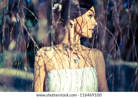 Beautiful Bride with diamonds posing in nature