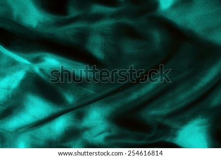 blue background abstract cloth of wavy folds of silk texture satin or velvet material or  wallpaper design of elegant curves blue material