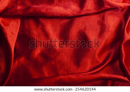 red background abstract cloth of wavy folds of silk texture satin or velvet material or  wallpaper design of elegant curves red material