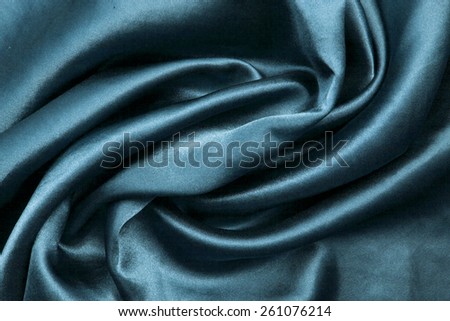 green background abstract cloth of wavy folds of silk texture satin or velvet material or design of elegant curves green material