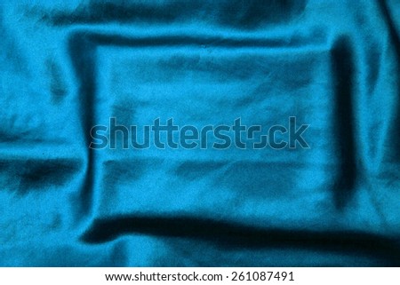 blue background abstract cloth of wavy folds of silk texture satin or velvet material or  wallpaper design of elegant curves blue material