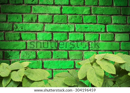 Background of old vintage brick wall , with leafes frame ,  brick wall closeup with floral frame