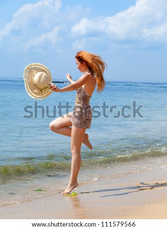 The girl jumps on an ocean coast
