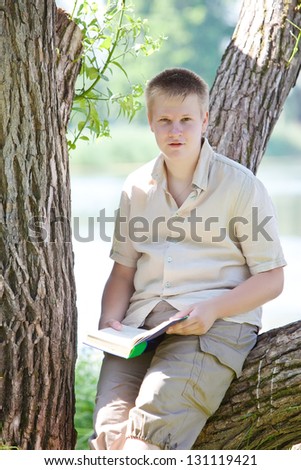 The young man (the pupil, the student) reads the book on the river bank