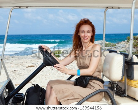 Women by golf car on the seashore. Mexico. Women Island