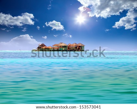 Island in ocean, overwater villas