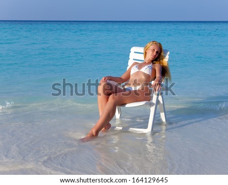 The girl in a beach chair at ocean