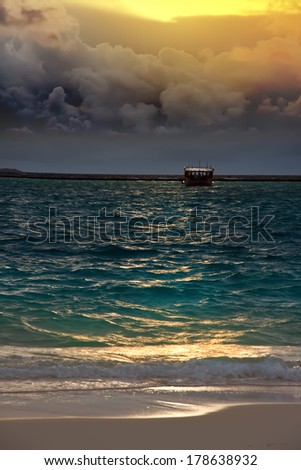 The boat in the sea, storm, sunset