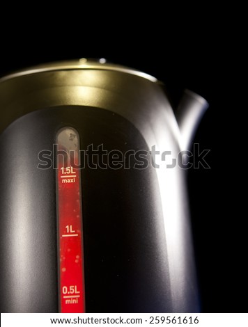 Measured mark water level of the electric kettle, red color - a boiling sign