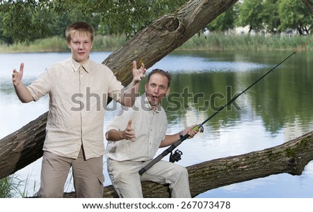 The father with the son on fishing, shows the size of fish