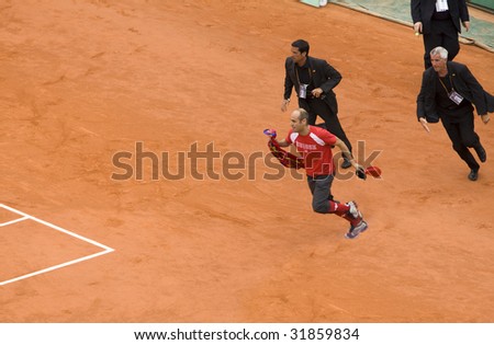 PARIS - JUNE 7: Infringer ran in on court with flag at French Open, Roland Garros on June 7, 2009 in Paris, France.