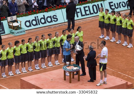 PARIS - JUNE 7: Andre Agassi cup delivers to Roger Federer of Switzerland for victory  at Tennis tournament French Open, Roland Garros, final game on June 7, 2009 in Paris, France.