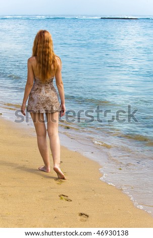 Young graceful woman goes on Oceanside