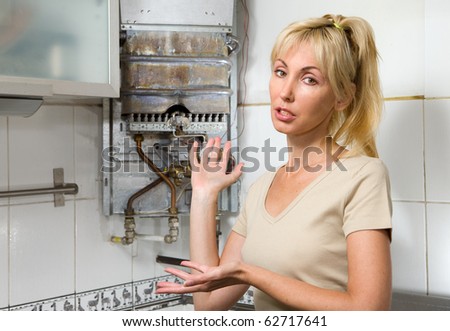 The young woman is upset by that the gas water heater has broken
