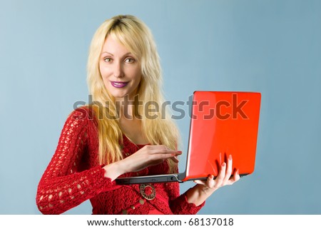 The young beautiful woman in  red blouse  with the red laptop