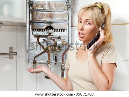 The young woman the housewife calls in a workshop on repair of gas water heaters