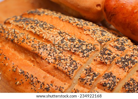 close up ftesh bread with poppy seeds and sesame seeds