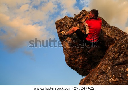 climber climbing on rock.  Strong male climber with copy space